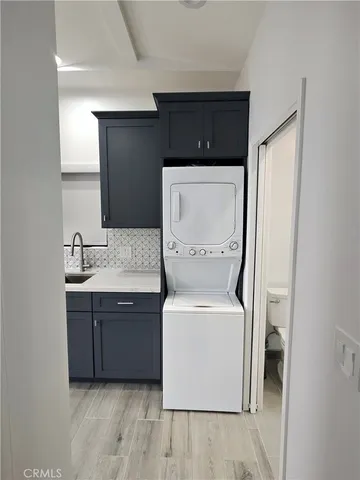 a utility room with a sink washer and dryer