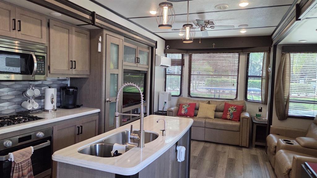 431 Waterway Drive River Ranch, FL 33867 - Photo 11 of 26 a kitchen with stainless steel appliances granite countertop a sink a stove and a refrigerator