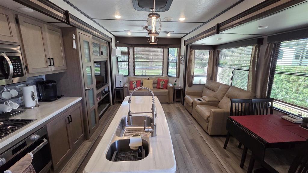 431 Waterway Drive River Ranch, FL 33867 - Photo 13 of 26 a living room with furniture and a floor to ceiling window