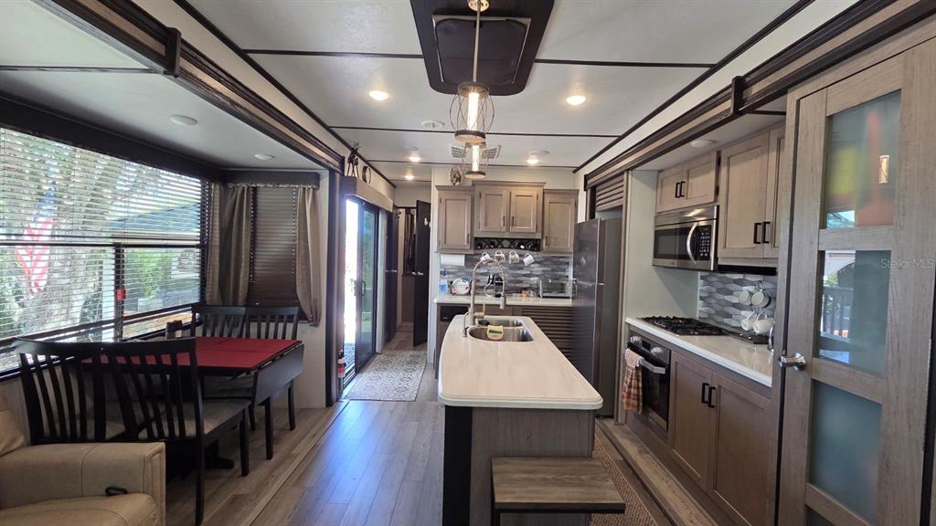 431 Waterway Drive River Ranch, FL 33867 - Photo 16 of 26 a kitchen with stainless steel appliances granite countertop a refrigerator a stove top oven a sink and dishwasher