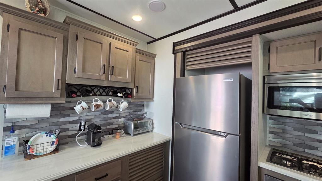 431 Waterway Drive River Ranch, FL 33867 - Photo 18 of 26 a kitchen with refrigerator and cabinets