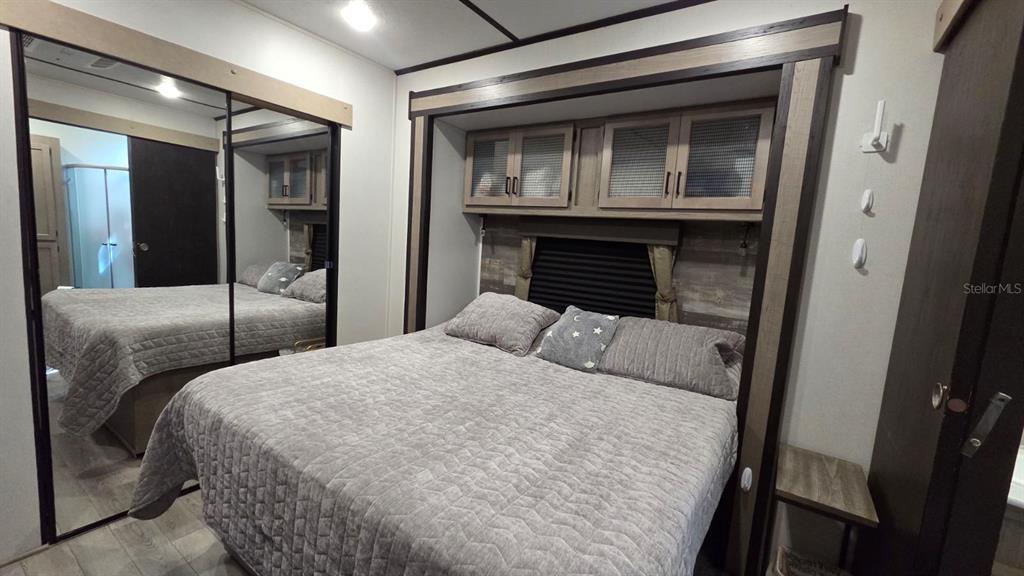 431 Waterway Drive River Ranch, FL 33867 - Photo 22 of 26 a bedroom with a bed and a mirror