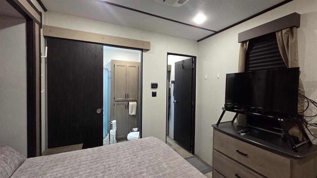 431 Waterway Drive River Ranch, FL 33867 - Photo 23 of 26 a bedroom with a bed and a flat screen tv