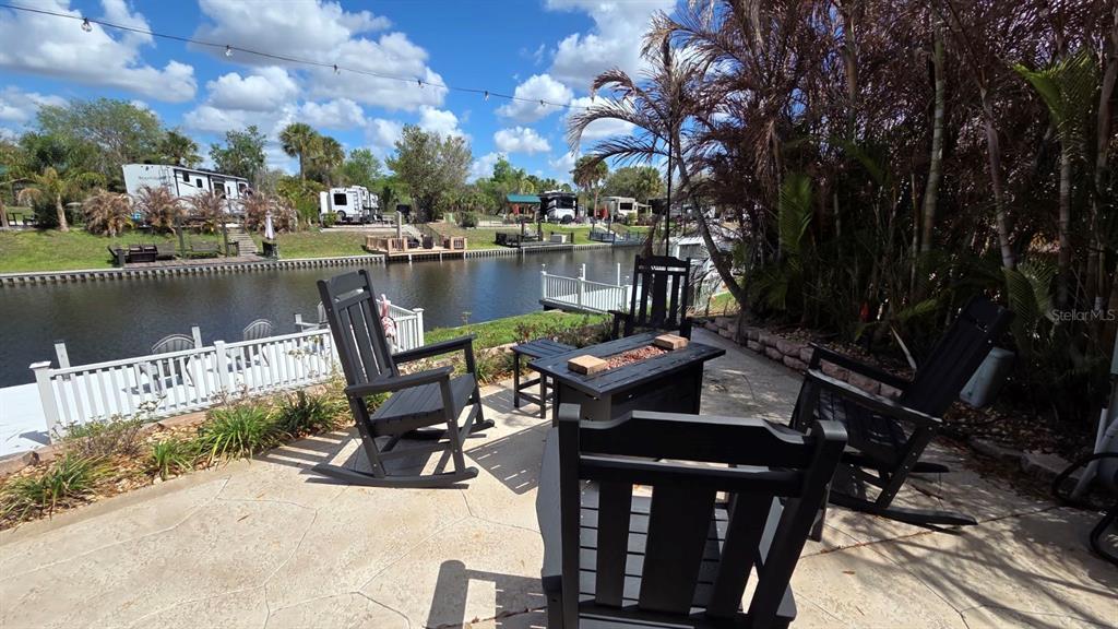 431 Waterway Drive River Ranch, FL 33867 - Photo 5 of 26 a view of a lake with a table and chairs