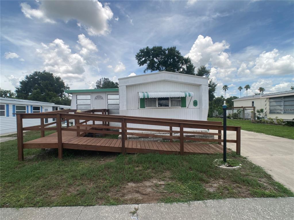 1710 7th Street Southwest, Unit 82 Ruskin, FL 33570 - Photo 1 of 19 a view of a chairs and table in the garden
