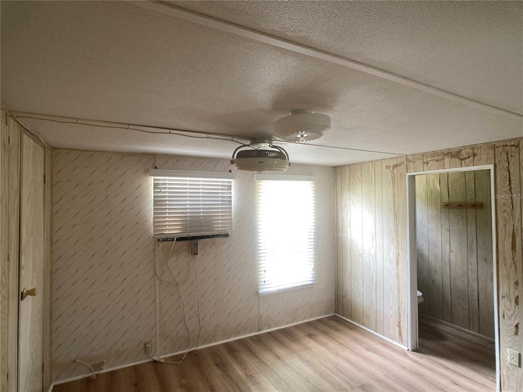 1710 7th Street Southwest, Unit 82 Ruskin, FL 33570 - Photo 15 of 19 a view of empty room with wooden floor and fan