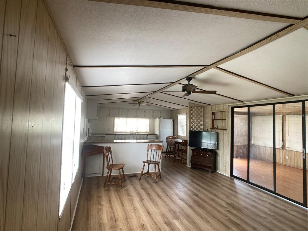 1710 7th Street Southwest, Unit 82 Ruskin, FL 33570 - Photo 10 of 19 a dining room with stainless steel appliances granite countertop furniture a refrigerator and kitchen view