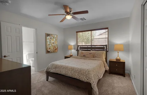 a bedroom with a bed and a lamp on table