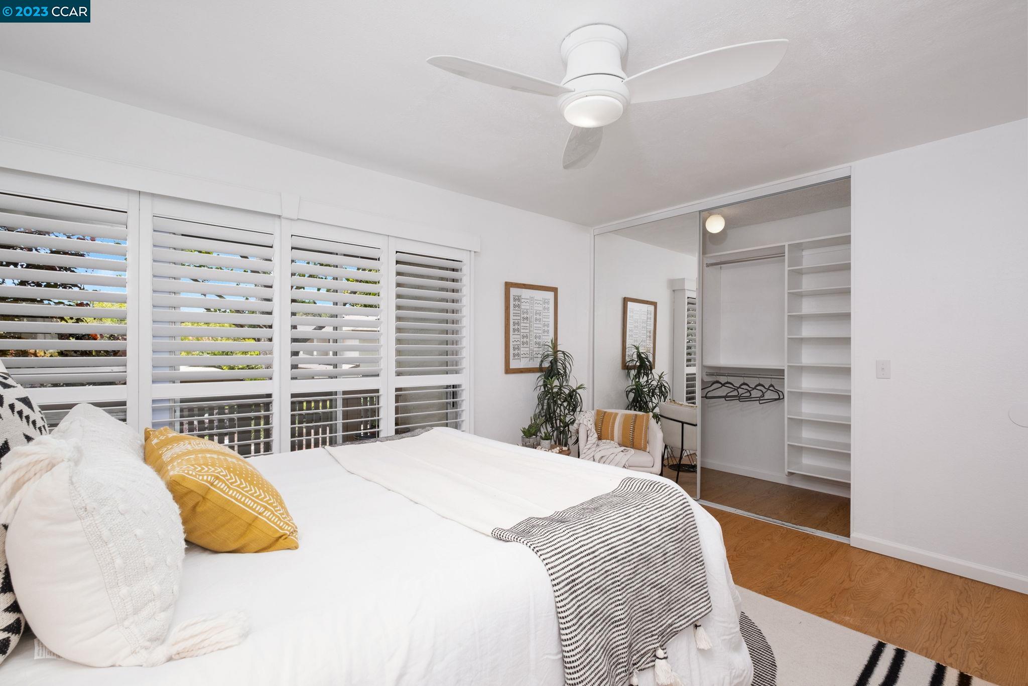1875 Pomar Way Walnut Creek, CA 94598 - Photo 20 of 32 a bedroom with a bed and a chandelier
