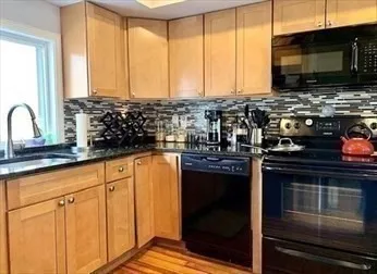 a kitchen with stainless steel appliances a stove sink and microwave