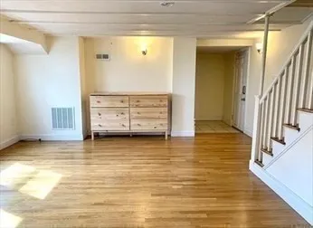 a view of room with wooden floor