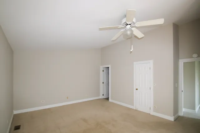 an empty room with a fan and a fan