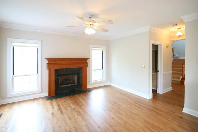 a view of a livingroom with a fireplace wooden floor and a window