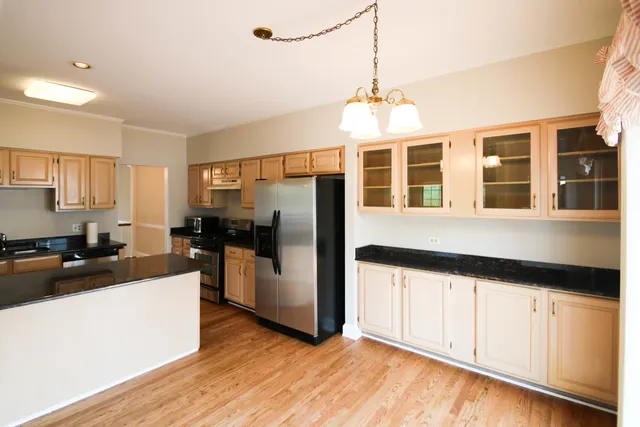 a kitchen with stainless steel appliances a refrigerator sink and cabinets