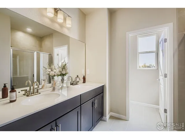 a bathroom with a shower and a glass door