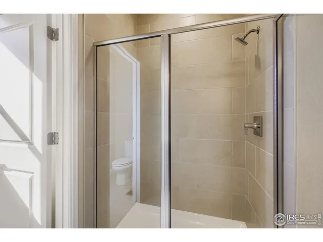 a view of walk in closet with clothes