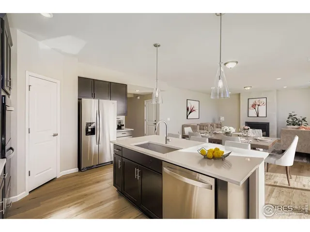 a kitchen with a sink a counter and chairs