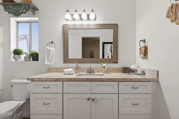 a bathroom with a sink vanity and a mirror