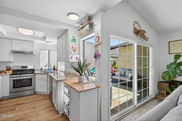 a kitchen with stainless steel appliances a stove a sink and a refrigerator