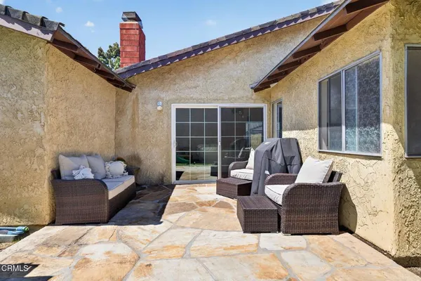 a view of a house with backyard and sitting area