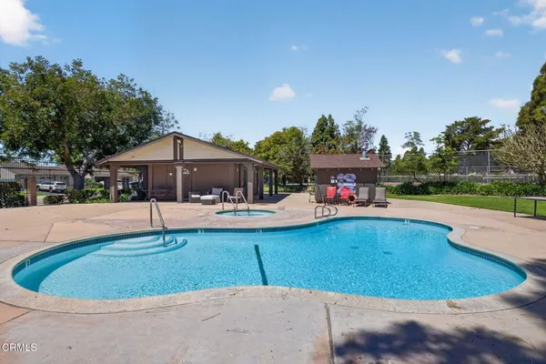 a view of a swimming pool with an outdoor seating