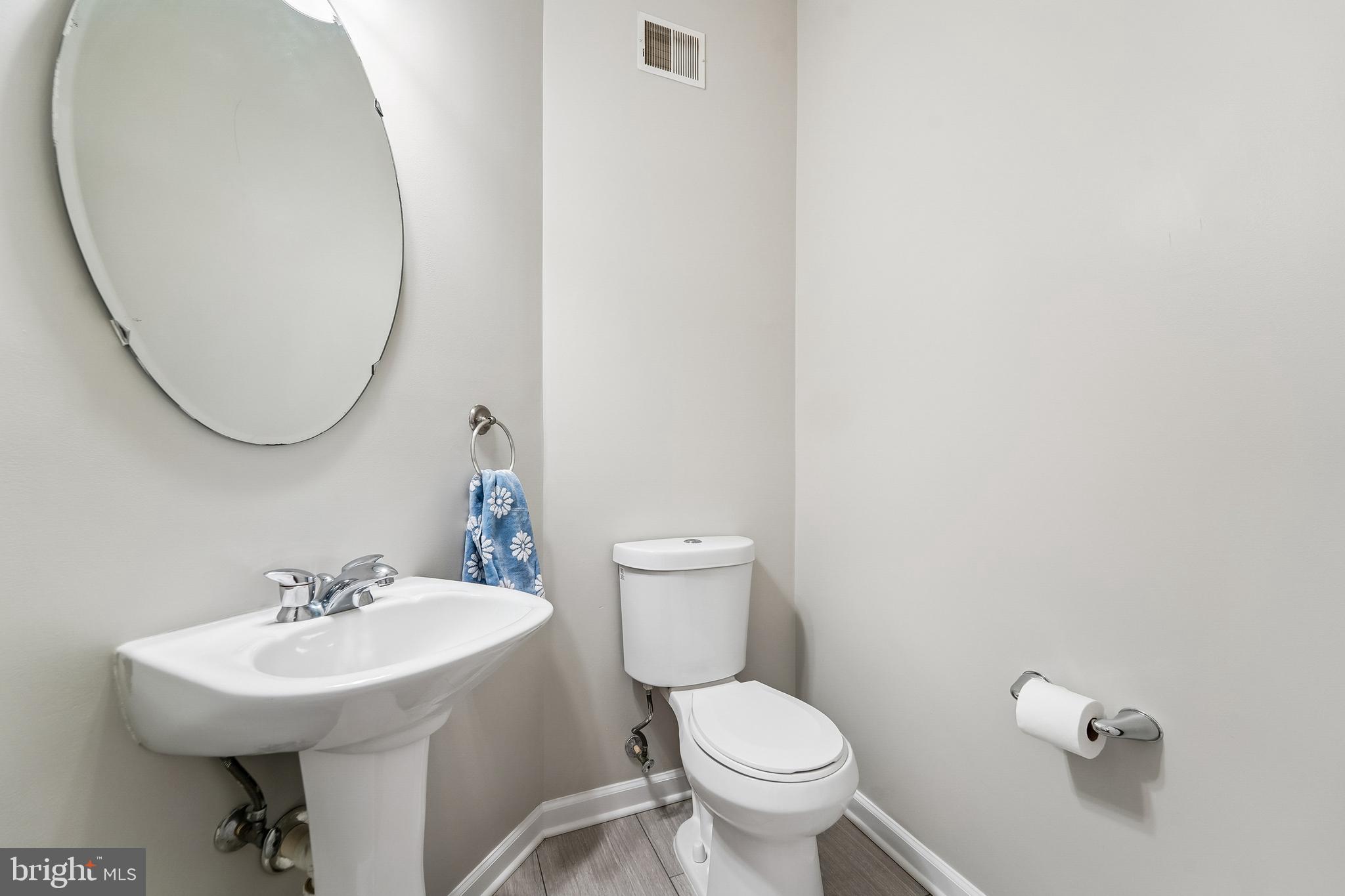 1461 Pangbourne Way Hanover, MD 21076 - Photo 6 of 51 a bathroom with a sink a toilet and a mirror