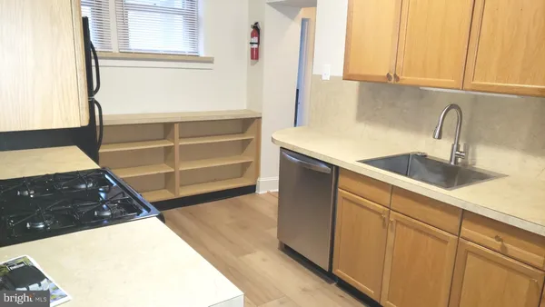 a kitchen with a sink and a stove
