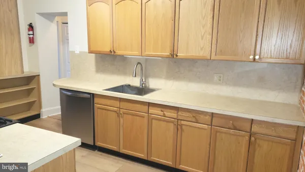 a kitchen with stainless steel appliances granite countertop white cabinets and a sink