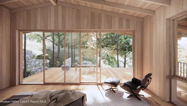 a living room with a floor to ceiling window and floor to ceiling window