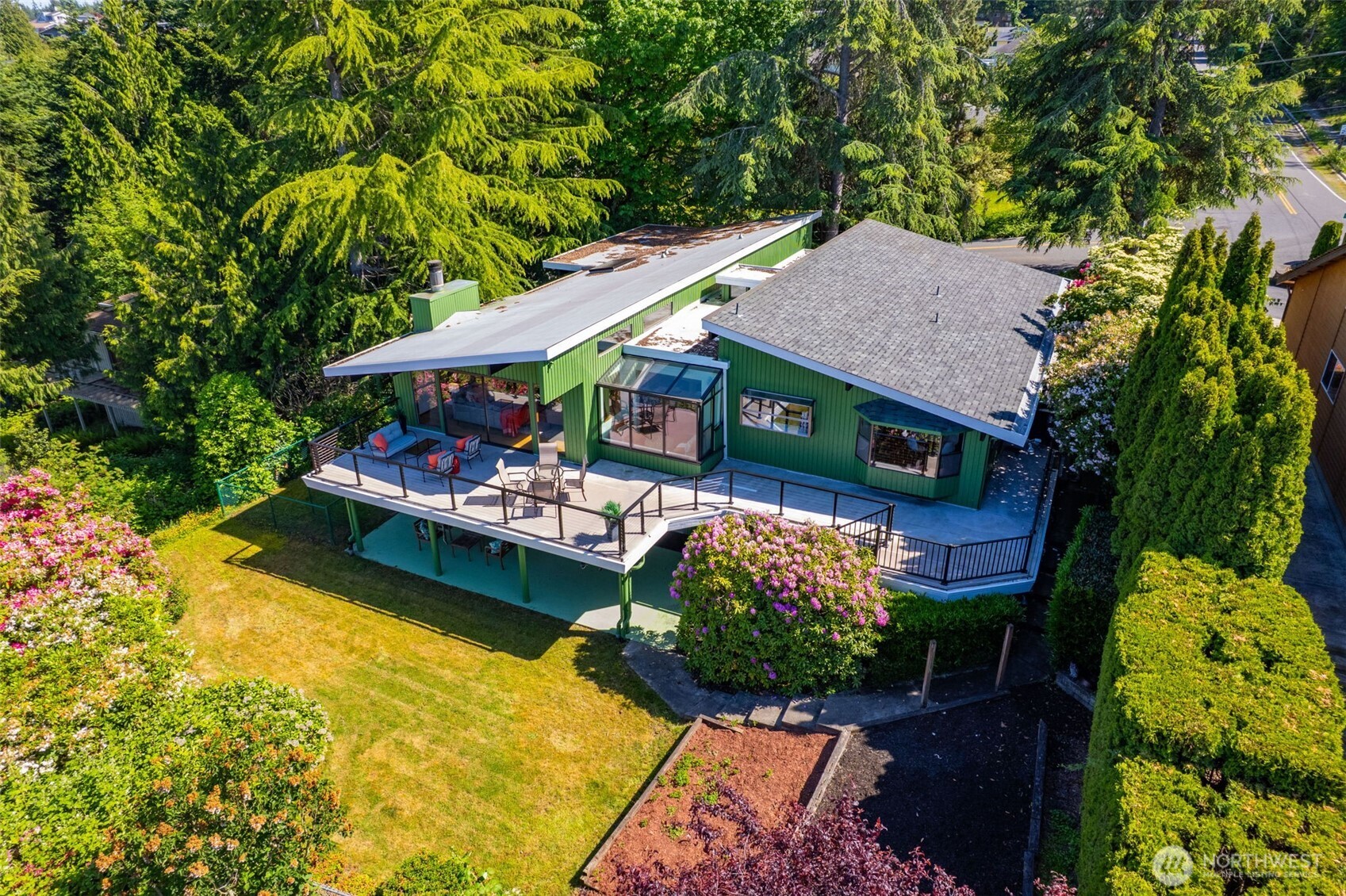 an aerial view of a house with swimming pool garden and patio