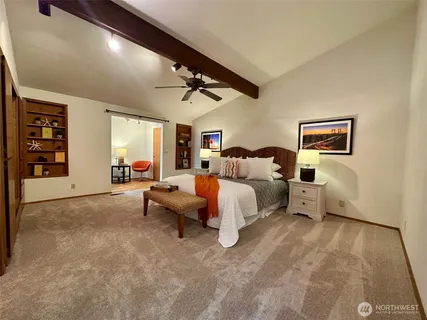 a bedroom with a bed closet and a mirror