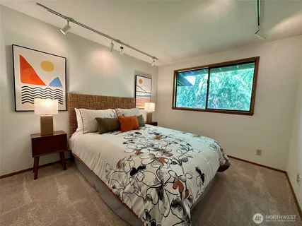 a bathroom with a toilet a mirror and shower