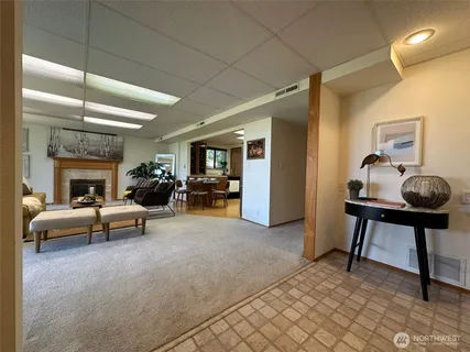 a kitchen with refrigerator and chairs