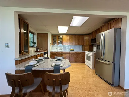 a kitchen with stainless steel appliances a refrigerator sink and microwave