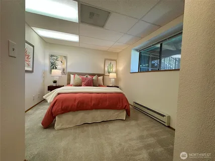 a bedroom with a bed and a window