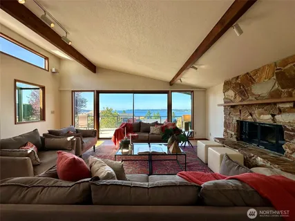 a living room with furniture fireplace and a large window