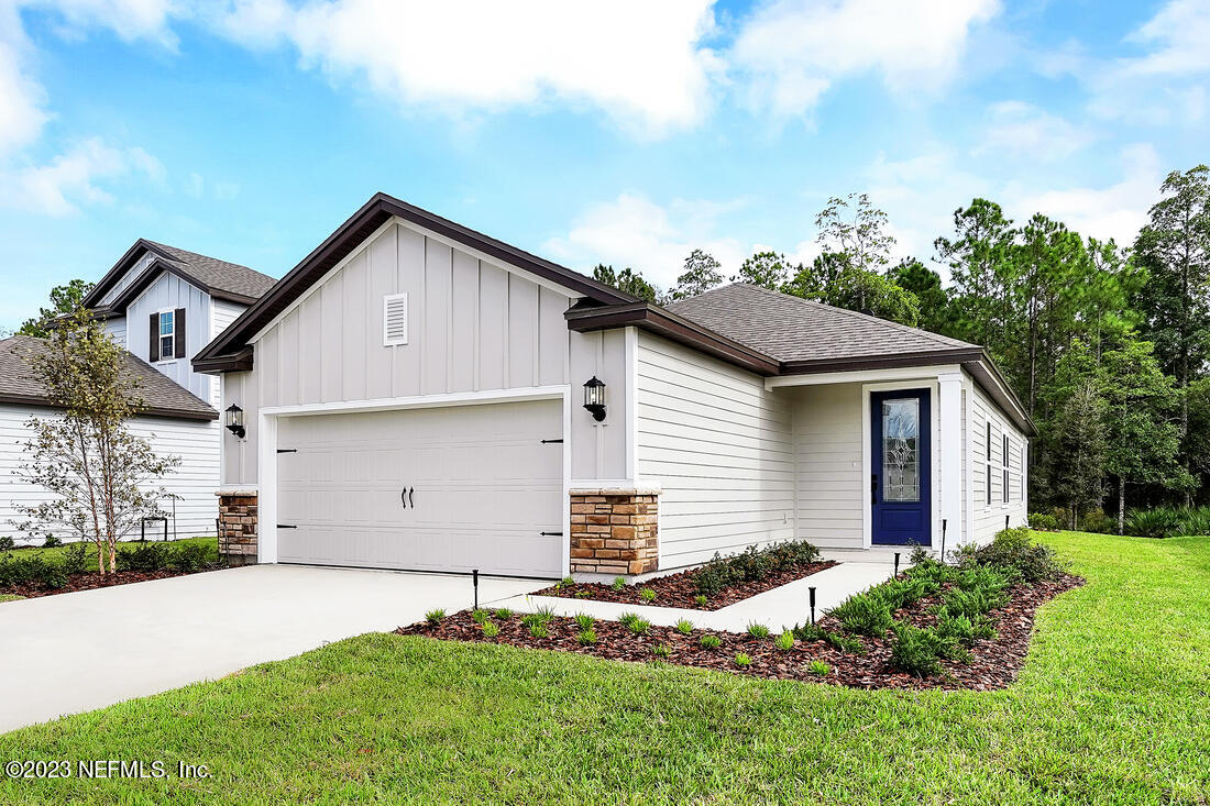 1024 Morgans Treasure Road St. Augustine, FL 32084 - Photo 1 of 8 a front view of a house with a yard and garage