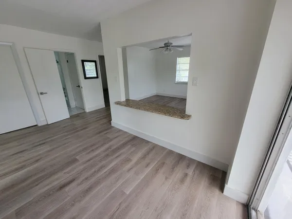 wooden floor in an empty room with a mirror