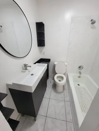 a bathroom with a sink mirror and toilet