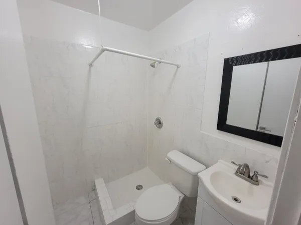 a bathroom with a toilet sink and shower