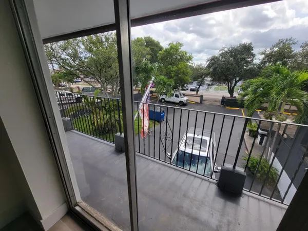 a view of a porch with wooden floor and outdoor seating