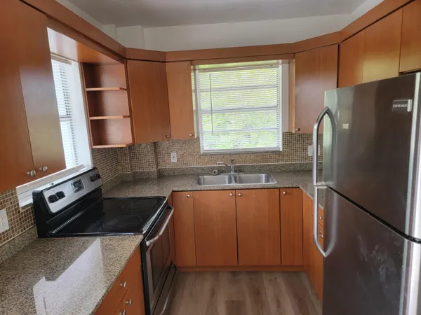 a kitchen with a refrigerator and a sink