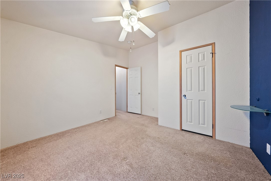 1391 East Casey Road Pahrump, NV 89048 - Photo 22 of 40 Unfurnished bedroom with carpet floors and a ceiling fan