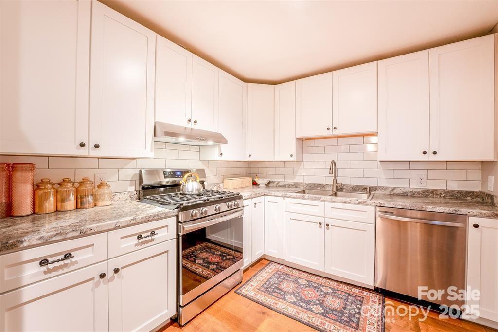 4805 Nesbit Road Monroe, NC 28112 - Photo 11 of 40 a kitchen with granite countertop white cabinets and white appliances