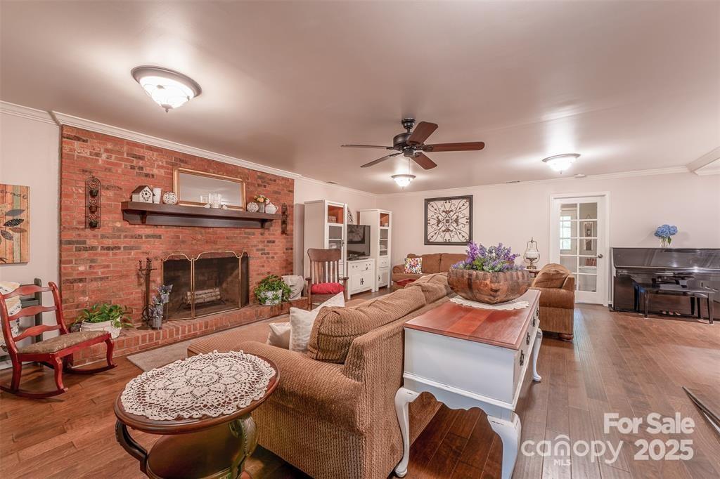 4805 Nesbit Road Monroe, NC 28112 - Photo 13 of 40 a living room with furniture a fireplace and a flat screen tv