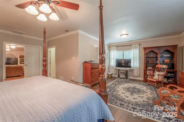 a bedroom with furniture and a mirror