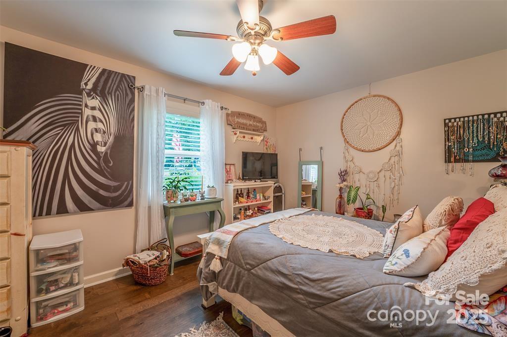 4805 Nesbit Road Monroe, NC 28112 - Photo 25 of 40 a bedroom with a bed and a chandelier