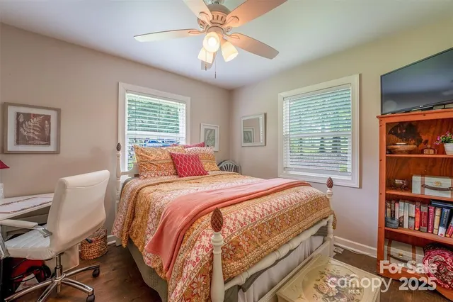 a bedroom with a bed a bookshelf and a bookshelf