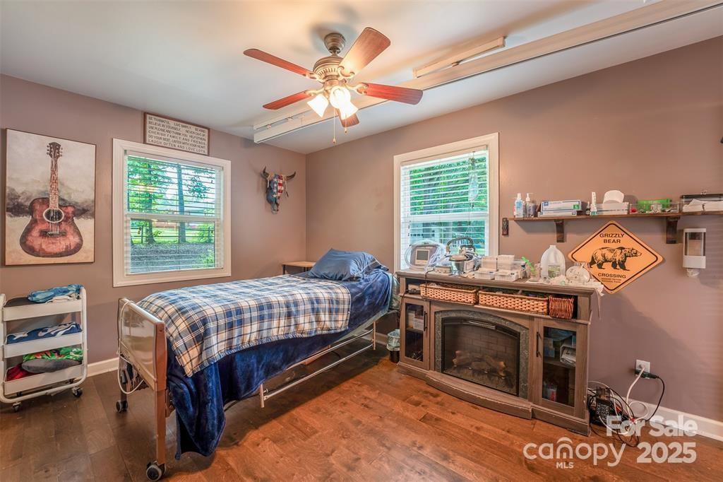 4805 Nesbit Road Monroe, NC 28112 - Photo 29 of 40 a bedroom with a bed and a chandelier