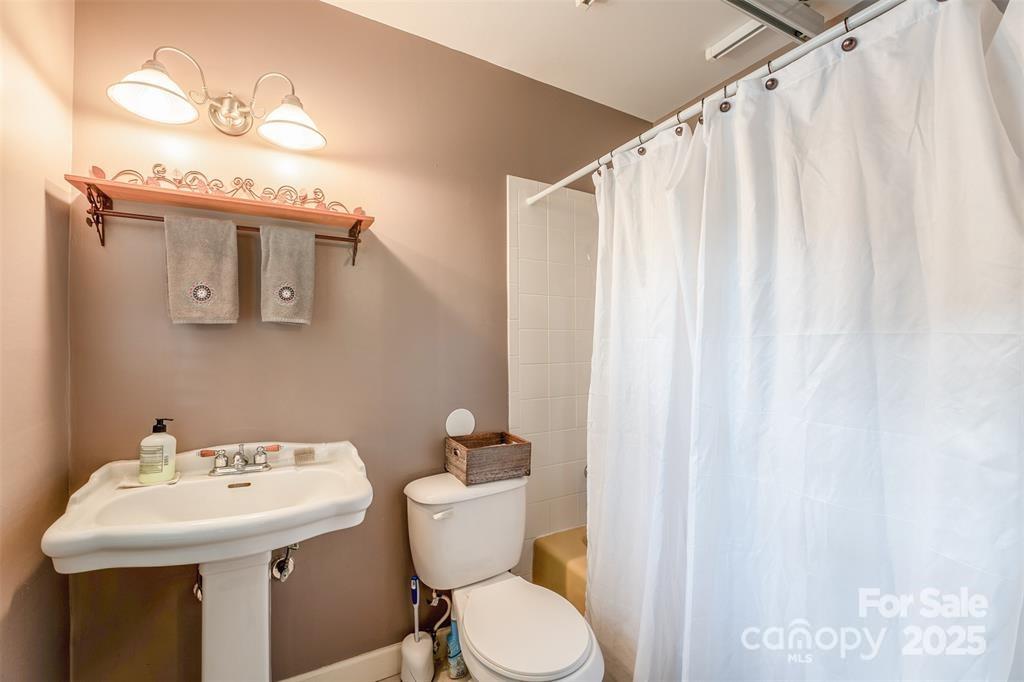 4805 Nesbit Road Monroe, NC 28112 - Photo 31 of 40 a bathroom with a sink and mirror with toilet